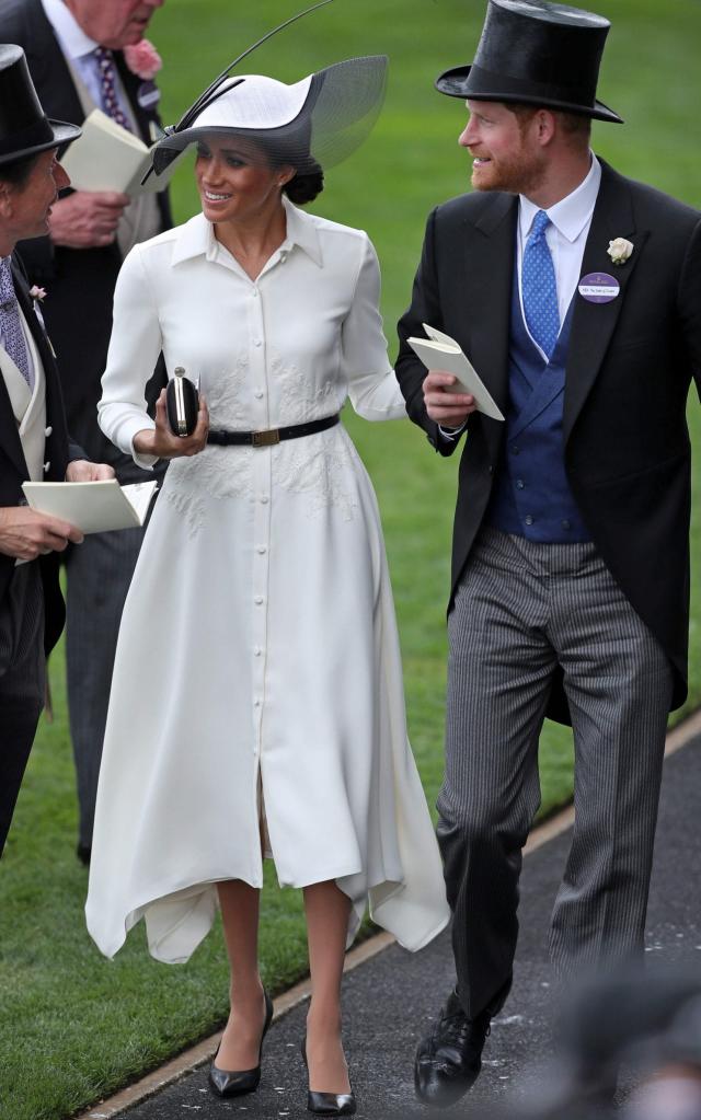 The Duchess of Sussex wears a Givenchy shirt dress and Philip Treacy hat at Royal Ascot - AFP
