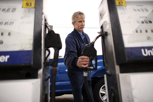 In this Tuesday, March 26, 2019 photo, Eddie Cartwright finishes gassing up a pick-up in South Mills, N.C. Gas stations have evolved dramatically since the country's first drive-in service station opened in Pennsylvania in 1913, according to the Smithsonian Institution. For most, the decline in service was all about economics. Let people pump their own gas, except in New Jersey, the only state that won't allow it and get their car serviced somewhere else. (Stephen M. Katz/The Virginian-Pilot via AP)