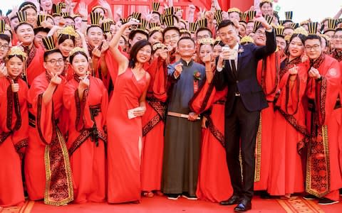 A total of 102 couples, each with at least one of the partners employed at the Alibaba Group, attend the Han Style group wedding - Credit: VCG via Getty Images