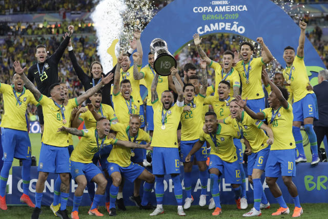 Brazil's Dani Alves lifts up the trophy after winning the final soccer match of the Copa America against Peru at the Maracana stadium in Rio de Janeiro, Brazil, Sunday, July 7, 2019. Brazil won the match 3-1. (AP Photo/Andre Penner)