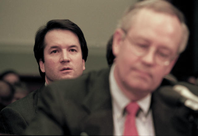 Brett Kavanaugh, associate counsel in the Office of Independent Counsel Kenneth Starr, sits behind Starr during his testimony before the House Judiciary Committee regarding the possible impeachment of President Bill Clinton on Nov. 19, 1998, in Washington, D.C. (Photo: David Hume Kennerly/Getty Images)