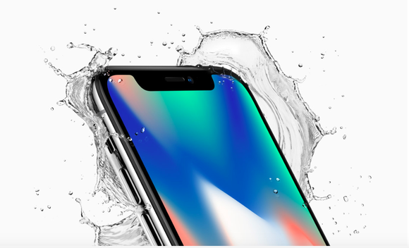 Apple's iPhoneX is shown with splashing water around it in a glossy advertisement photo