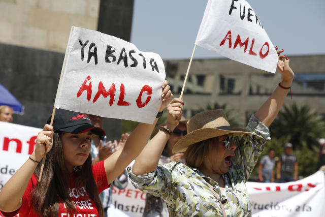 Protesters march against the policies of Mexican President Andrés Manuel López Obrador with signs that reads in Spanish 